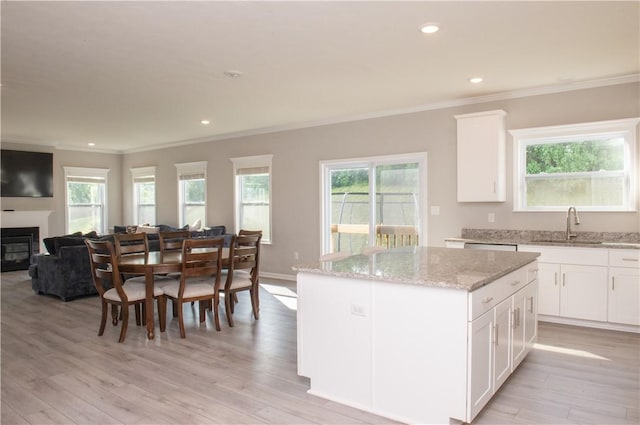 132 Hidden Acres Dr, Forward Twp, PA 16033 - kitchen with ornamental molding, light wood-style flooring, a center island, light stone countertops, and open floor plan
