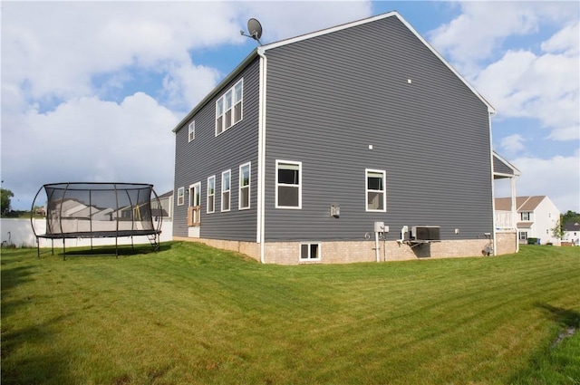 132 Hidden Acres Dr, Forward Twp, PA 16033 - back of house with a trampoline and a yard