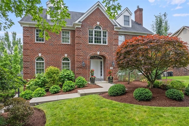 116 Bunker Hill Dr, Peters Twp, PA 15317 - colonial inspired home featuring a chimney, brick siding, a front yard, and a shingled roof