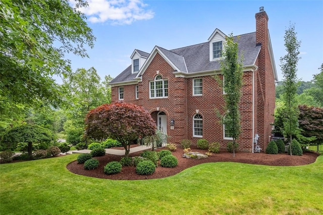 116 Bunker Hill Dr, Peters Twp, PA 15317 - colonial home featuring a front yard, a chimney, and brick siding