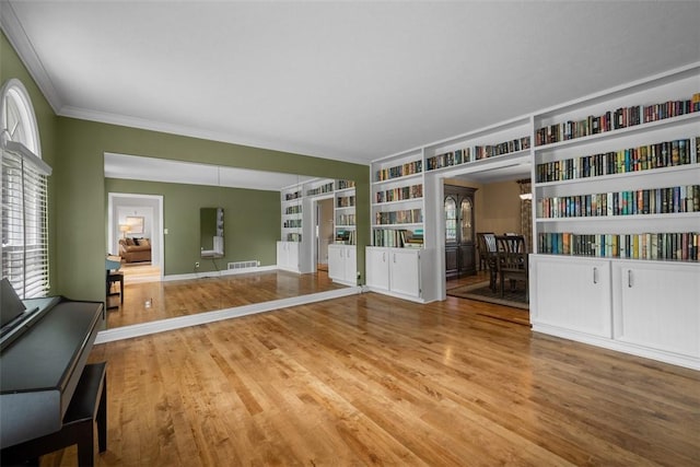 116 Bunker Hill Dr, Peters Twp, PA 15317 - unfurnished living room featuring wood finished floors, built in features, and ornamental molding