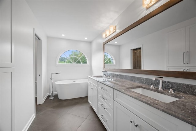 116 Bunker Hill Dr, Peters Twp, PA 15317 - bathroom featuring a freestanding bath, double vanity, tile patterned floors, and recessed lighting