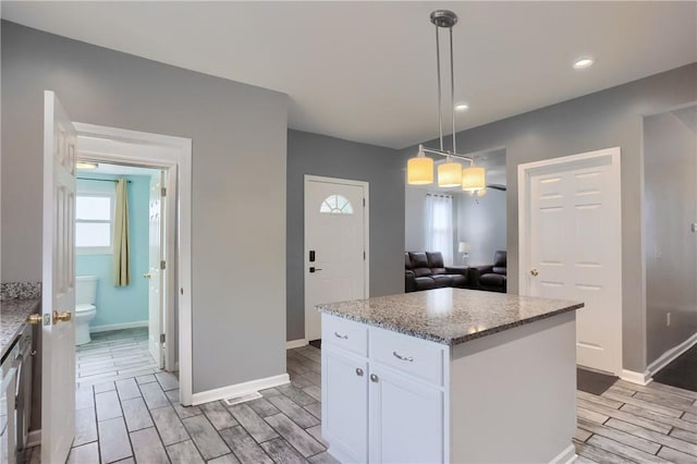 1707 Cosmos St, Lincoln Place, PA 15207 - kitchen featuring white cabinetry, light stone counters, wood finish floors, hanging light fixtures, and recessed lighting