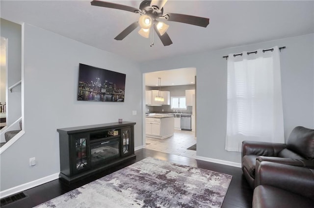 1707 Cosmos St, Lincoln Place, PA 15207 - living area featuring stairs, ceiling fan, and wood finished floors