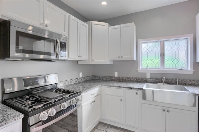 1707 Cosmos St, Lincoln Place, PA 15207 - kitchen featuring stainless steel appliances, white cabinets, light stone counters, and recessed lighting