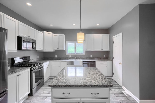 1707 Cosmos St, Lincoln Place, PA 15207 - kitchen featuring appliances with stainless steel finishes, a center island, light stone counters, white cabinets, and recessed lighting