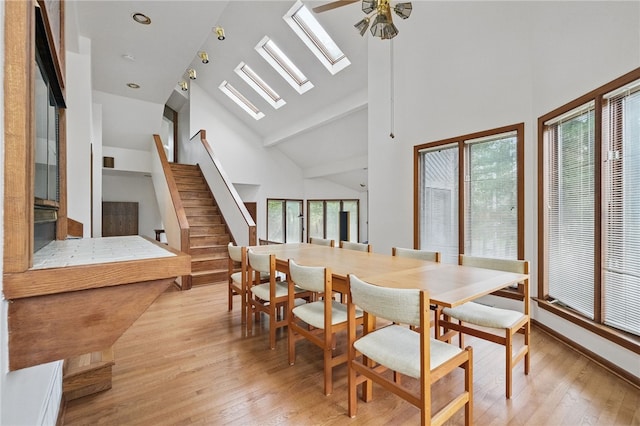 1 Quail Hill Rd, Fox Chapel, PA 15238 - dining room featuring light wood finished floors, a skylight, high vaulted ceiling, stairway, and ceiling fan