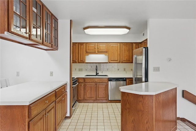 1 Quail Hill Rd, Fox Chapel, PA 15238 - kitchen featuring stainless steel appliances, a peninsula, light tile patterned flooring, decorative backsplash, and brown cabinetry