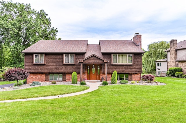 317 Bridlewood Dr, Hempfield Twp Wml, PA 15601 - bi-level home with a front lawn, a shingled roof, a chimney, and brick siding