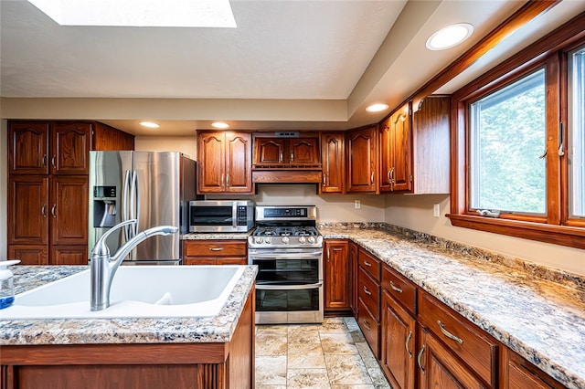 317 Bridlewood Dr, Hempfield Twp Wml, PA 15601 - kitchen with stainless steel appliances, plenty of natural light, under cabinet range hood, recessed lighting, and brown cabinetry
