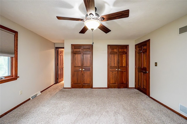 317 Bridlewood Dr, Hempfield Twp Wml, PA 15601 - unfurnished bedroom with carpet flooring, multiple closets, and a ceiling fan