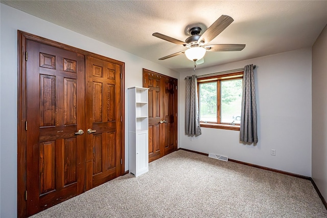 317 Bridlewood Dr, Hempfield Twp Wml, PA 15601 - unfurnished bedroom featuring light carpet, two closets, and a ceiling fan