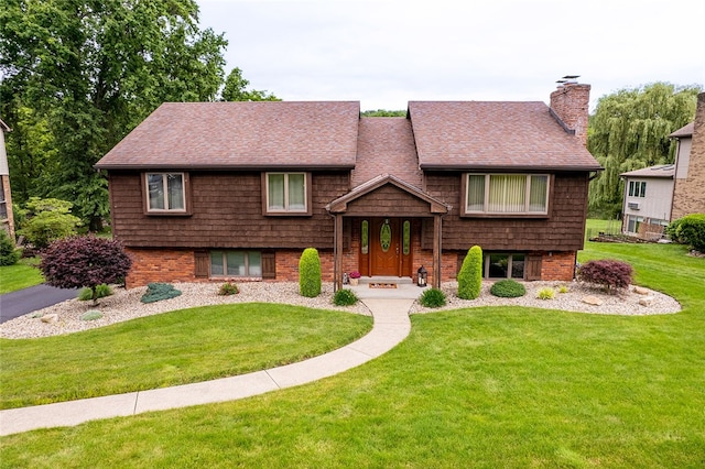 317 Bridlewood Dr, Hempfield Twp Wml, PA 15601 - view of front of house featuring a front yard, a shingled roof, and a chimney