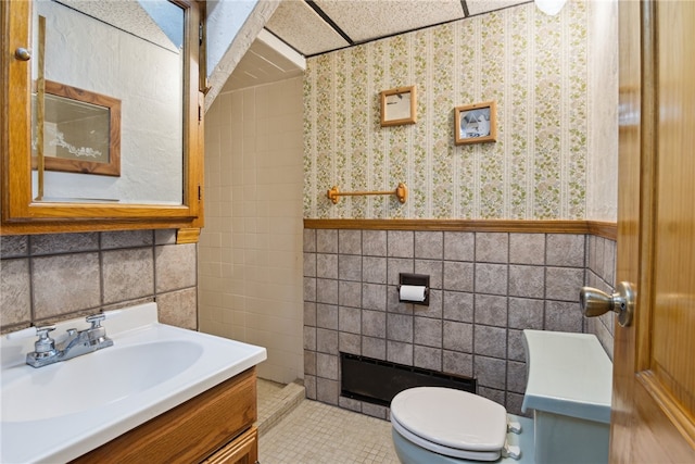 1343 Venetia Rd, Nottingham, PA 15330 - bathroom featuring tile walls, vanity, wallpapered walls, a wainscoted wall, and tile patterned floors
