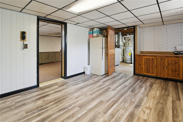 1343 Venetia Rd, Nottingham, PA 15330 - unfurnished living room with water heater, wood finished floors, a drop ceiling, washer / dryer, and wood walls