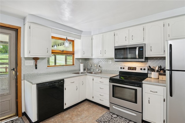 1343 Venetia Rd, Nottingham, PA 15330 - kitchen featuring stainless steel appliances, decorative backsplash, white cabinetry, and light countertops