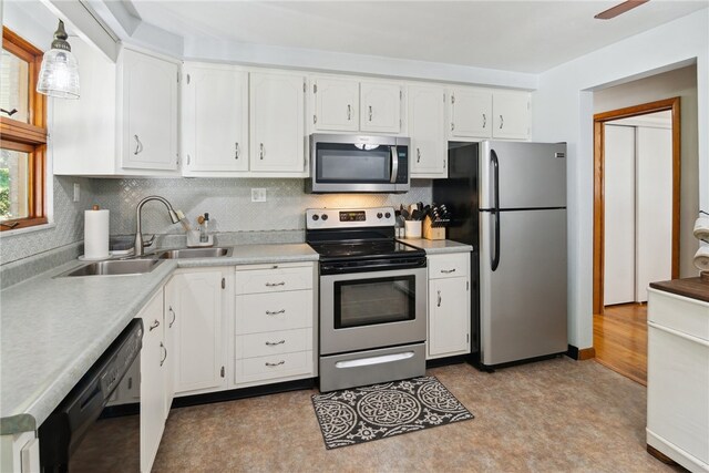 1343 Venetia Rd, Nottingham, PA 15330 - kitchen with stainless steel appliances, light floors, white cabinetry, and decorative backsplash