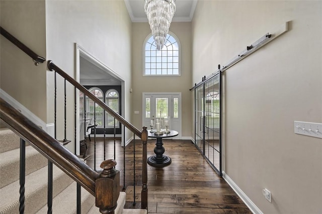 306 Hedgerow Dr, Peters Twp, PA 15367 - foyer with ornamental molding, healthy amount of natural light, dark wood finished floors, stairway, and a chandelier