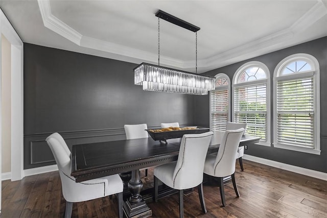 306 Hedgerow Dr, Peters Twp, PA 15367 - dining space featuring a tray ceiling, a chandelier, dark wood-type flooring, and crown molding