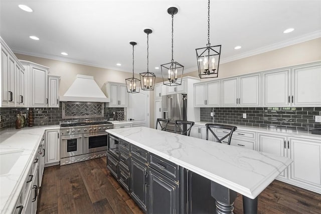 306 Hedgerow Dr, Peters Twp, PA 15367 - kitchen with high quality appliances, premium range hood, white cabinetry, crown molding, and recessed lighting