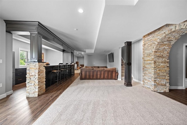 306 Hedgerow Dr, Peters Twp, PA 15367 - living area with dark wood-type flooring, bar area, recessed lighting, arched walkways, and stairs