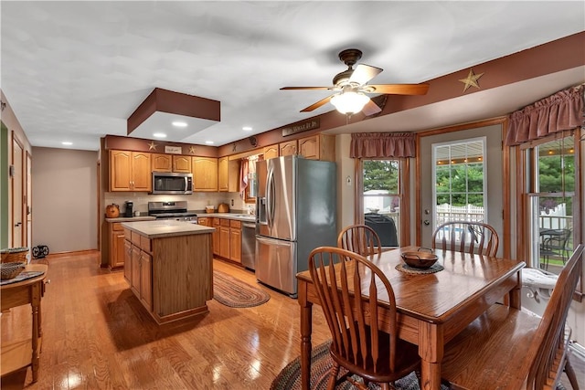 108 Birchwood Way, Penn Twp Wml, PA 15642 - kitchen featuring appliances with stainless steel finishes, a ceiling fan, light countertops, a center island, and light wood-style floors