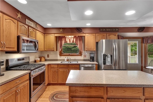 108 Birchwood Way, Penn Twp Wml, PA 15642 - kitchen featuring appliances with stainless steel finishes, a kitchen island, recessed lighting, decorative backsplash, and light wood-style floors