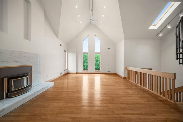 240 Rte 88, Monongahela, PA 15063 - unfurnished living room with hardwood / wood-style flooring, a ceiling fan, a skylight, and high vaulted ceiling