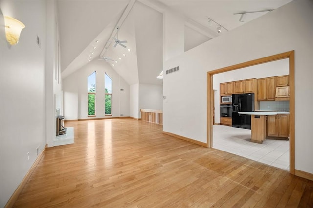 240 Rte 88, Monongahela, PA 15063 - unfurnished living room featuring rail lighting, light wood-type flooring, high vaulted ceiling, and a ceiling fan