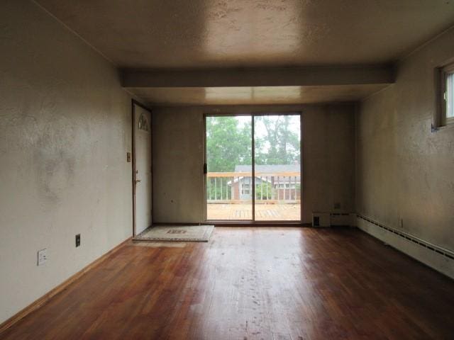 129 Windsor Dr, Penn Hills, PA 15235 - spare room featuring wood finished floors, plenty of natural light, and beamed ceiling