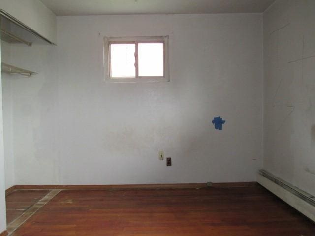 129 Windsor Dr, Penn Hills, PA 15235 - spare room with a baseboard heating unit and wood finished floors