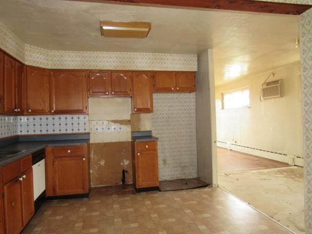 129 Windsor Dr, Penn Hills, PA 15235 - kitchen with a wall mounted air conditioner, wallpapered walls, light flooring, dark countertops, and brown cabinetry
