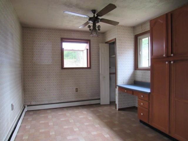 129 Windsor Dr, Penn Hills, PA 15235 - unfurnished bedroom featuring baseboard heating, wallpapered walls, an office area, light floors, and ceiling fan