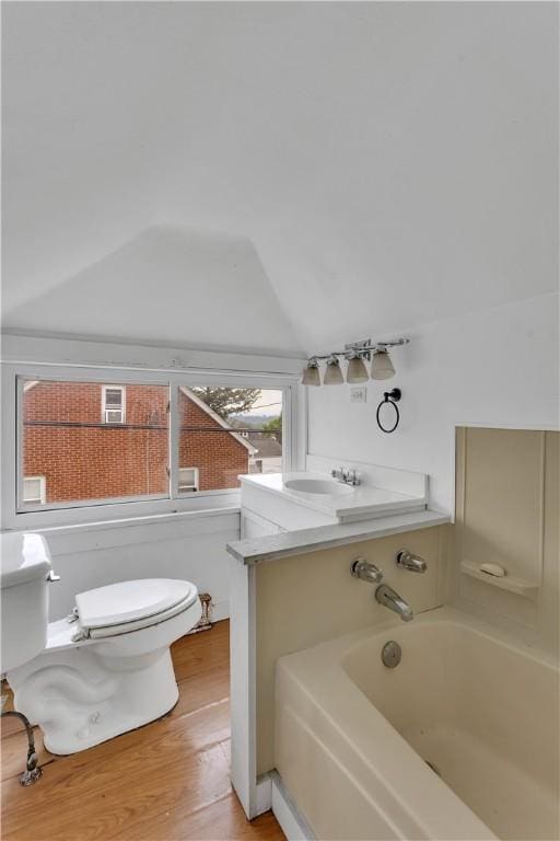 1505 Raymond Ave, Latrobe, PA 15650 - bathroom featuring a bathtub, wood finished floors, and lofted ceiling