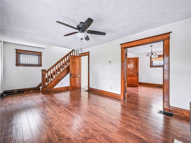 385 Spruce Ave, Sharon, PA 16146 - unfurnished living room with hardwood / wood-style floors, a textured ceiling, stairway, a ceiling fan, and a chandelier