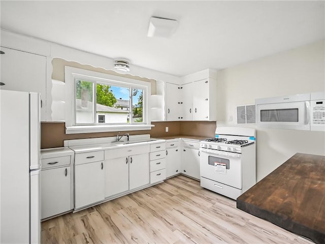 385 Spruce Ave, Sharon, PA 16146 - kitchen with white appliances, white cabinets, light wood-style flooring, light countertops, and open shelves