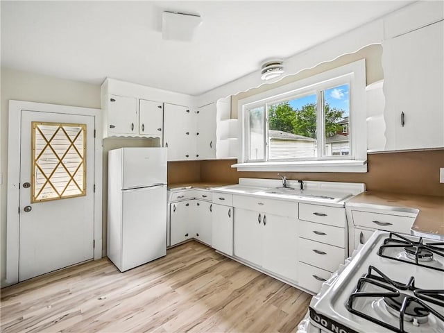 385 Spruce Ave, Sharon, PA 16146 - kitchen with white appliances, white cabinets, light countertops, and light wood-style flooring