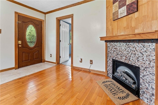 2228 Dinnerbell Five Forks Rd, Wharton Twp, PA 15437 - entrance foyer with a tile fireplace, light wood-type flooring, and crown molding