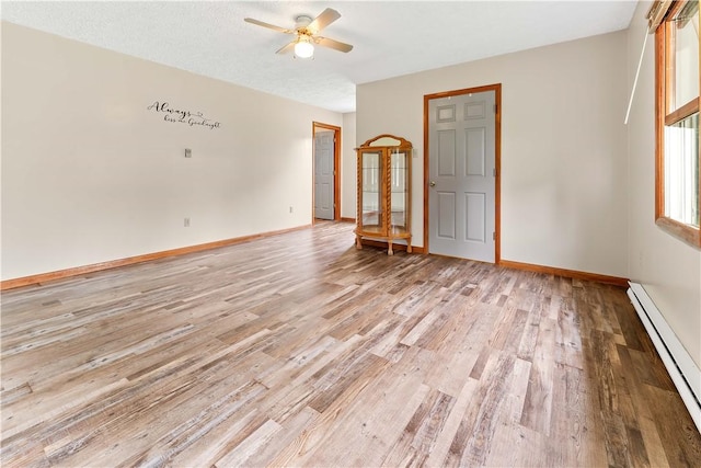 2228 Dinnerbell Five Forks Rd, Wharton Twp, PA 15437 - unfurnished room with a baseboard radiator, light wood-type flooring, and a ceiling fan