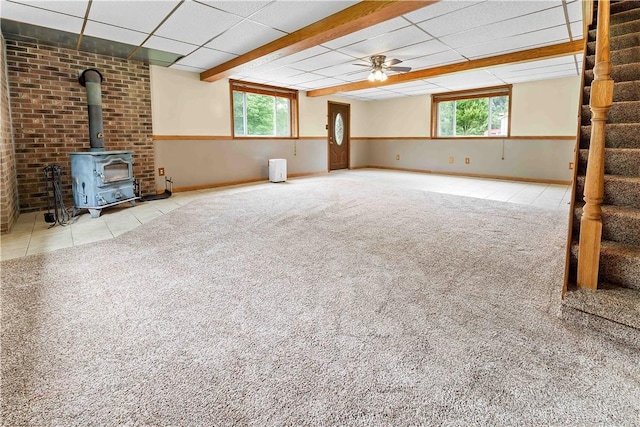2228 Dinnerbell Five Forks Rd, Wharton Twp, PA 15437 - unfurnished living room with a wood stove, carpet, stairs, a drop ceiling, and ceiling fan