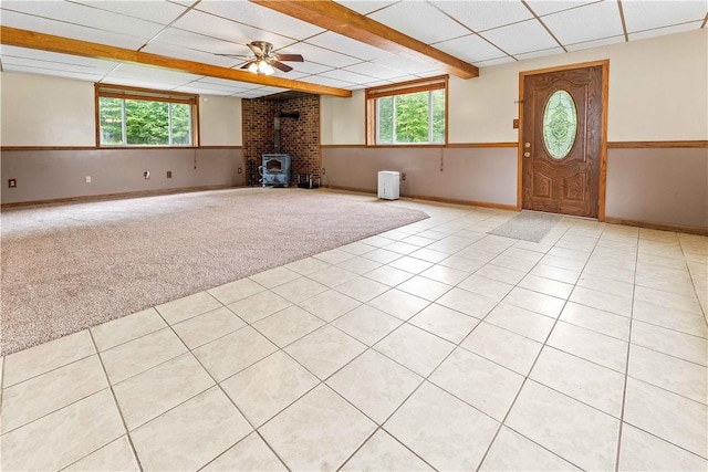 2228 Dinnerbell Five Forks Rd, Wharton Twp, PA 15437 - unfurnished living room with a wood stove, light carpet, ceiling fan, and light tile patterned floors