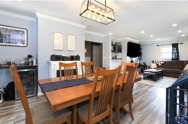 407 1st St, South Union Twp, PA 15401 - dining area with light wood-style flooring, wine cooler, crown molding, recessed lighting, and bar