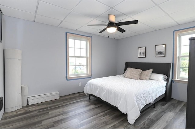 407 1st St, South Union Twp, PA 15401 - bedroom featuring a baseboard heating unit, a drop ceiling, wood finished floors, and ceiling fan