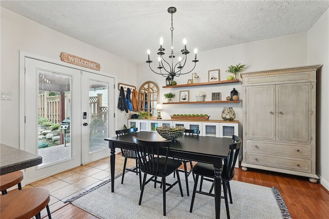 3236 Beacon Hill Ave, Dormont, PA 15216 - dining space with french doors, a chandelier, a textured ceiling, and wood finished floors