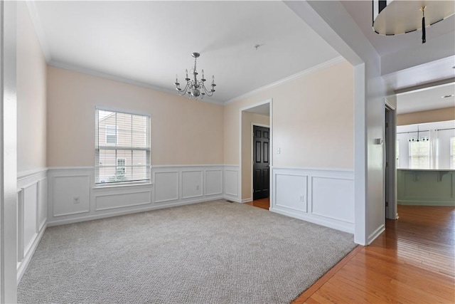 4015 Bentwood Dr, North Strabane, PA 15317 - unfurnished dining area featuring a chandelier, healthy amount of natural light, ornamental molding, wainscoting, and light wood-type flooring