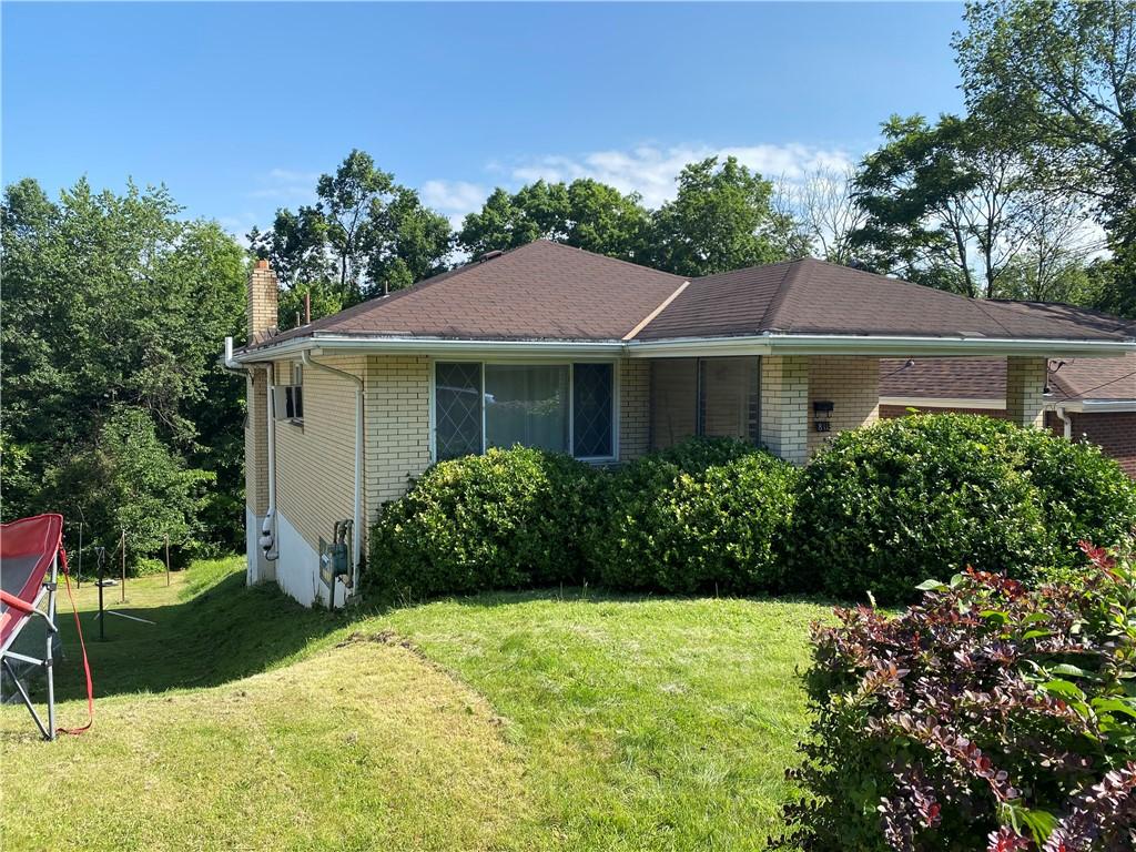 811 Worthington, Clairton, PA 15025 - view of home's exterior with a yard, a chimney, and brick siding
