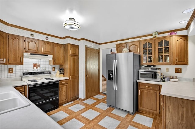12169 Pine Crest Ct, North Huntingdon, PA 15085 - kitchen featuring stainless steel appliances, under cabinet range hood, inlaid floor details, brown cabinetry, and ornamental molding