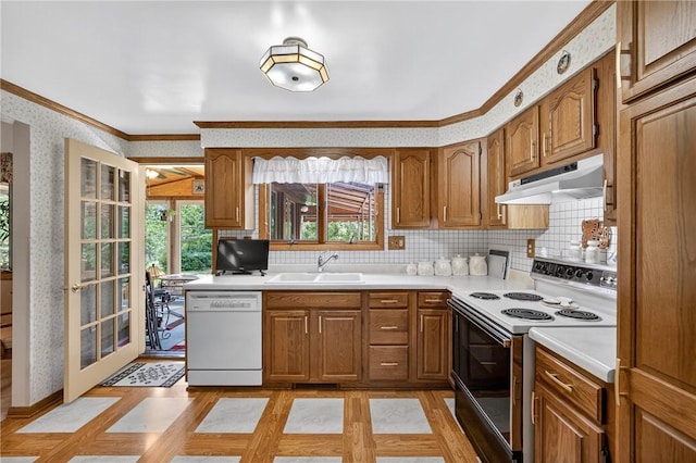 12169 Pine Crest Ct, North Huntingdon, PA 15085 - kitchen featuring white appliances, under cabinet range hood, ornamental molding, plenty of natural light, and brown cabinets