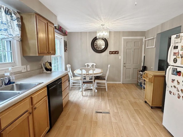 217 S Shady Ave, Chartiers, PA 15342 - kitchen featuring black dishwasher, freestanding refrigerator, light wood-style floors, a chandelier, and light countertops