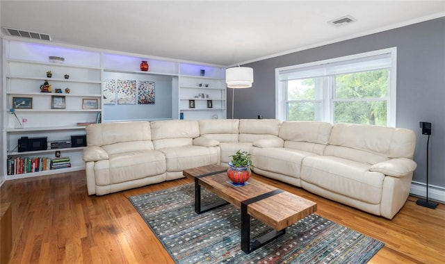 537 Center Church Rd, Peters Twp, PA 15317 - living area featuring wood finished floors, crown molding, built in shelves, and a baseboard heating unit